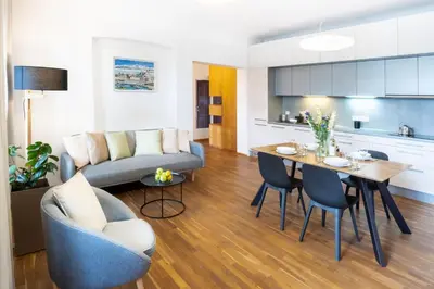 a living room with a couch and a table and chairs at River View Apartment in Prague