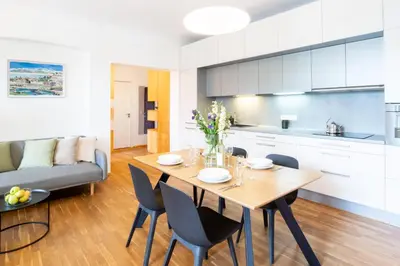 a kitchen and dining room with a table and chairs at River View Apartment in Prague