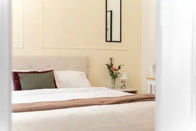 a bedroom with a white bed with a vase of flowers at 1# Fancy share Apartment with Own Bathroom in Prague
