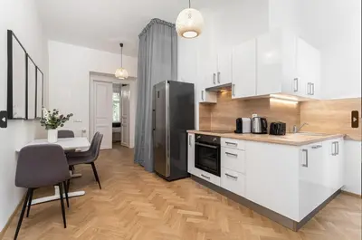 a kitchen with white cabinets and a black refrigerator at 1# Fancy share Apartment with Own Bathroom in Prague