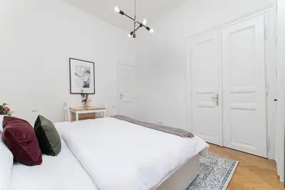 a white bedroom with two beds and a table at 1# Fancy share Apartment with Own Bathroom in Prague