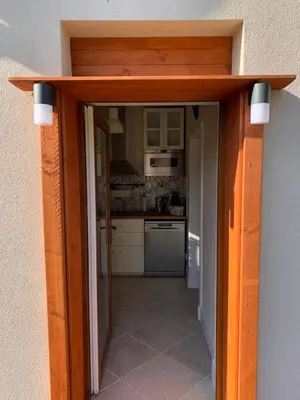 a doorway into a kitchen with a door open at Apartment Nedamov in Dubá