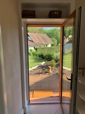 an open door to a patio with a view of a yard at Apartment Nedamov in Dubá
