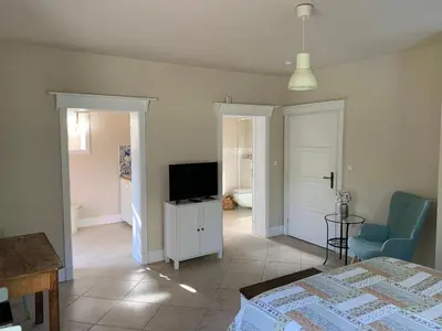 a bedroom with a bed and a tv in a room at Apartment Nedamov in Dubá