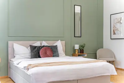 a bedroom with a large bed and a chair at 2# Fancy share Apartment with Own Bathroom in Prague