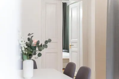 a dining room with a table and chairs and a mirror at 2# Fancy share Apartment with Own Bathroom in Prague