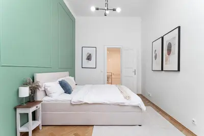 a bedroom with a white bed and green walls at 2# Fancy share Apartment with Own Bathroom in Prague