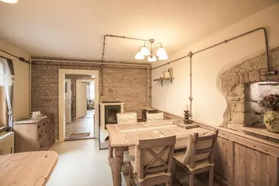 a dining room with a table and a mirror at Chalupa pod Řípem in Straškov