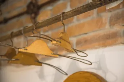three pairs of hats hanging from a brick wall at Chalupa pod Řípem in Straškov
