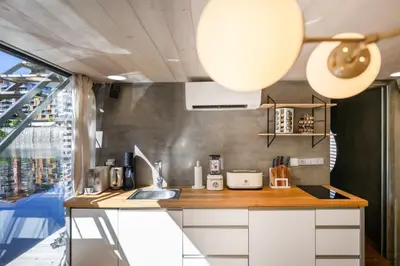 a kitchen with a counter with a sink and a window at Hausboat Holešovice in Prague