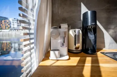 a coffee maker sitting on a counter next to a window at Hausboat Holešovice in Prague