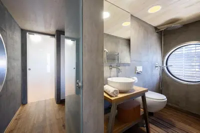 a bathroom with a sink and a toilet at Hausboat Holešovice in Prague