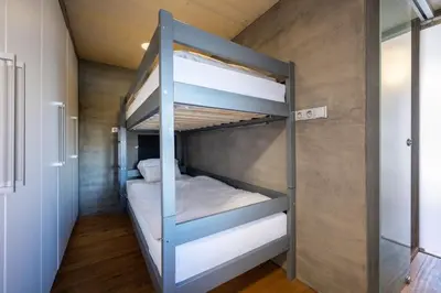 a bedroom with two bunk beds in a room at Hausboat Holešovice in Prague
