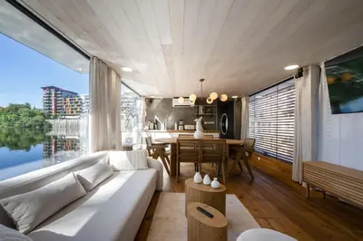 a living room with a white couch and a table at Hausboat Holešovice in Prague