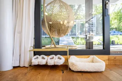 a living room with a table and a chandelier at Hausboat Holešovice in Prague