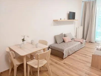 a living room with a table and a couch at Apartmán IRIS Poděbrady in Poděbrady