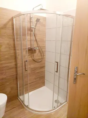a shower with a glass door in a bathroom at Apartmán IRIS Poděbrady in Poděbrady