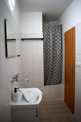 a bathroom with a sink and a shower at Penzion Škubánek in Mladá Boleslav