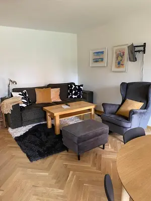 a living room with a couch and a table at 2+kk se vstupem na zahradu in Prague