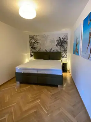 a bedroom with a bed in the corner of a room at 2+kk se vstupem na zahradu in Prague