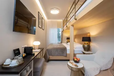 a hotel room with a bedroom and a bed at PAPPAS hotel&studio in Poděbrady