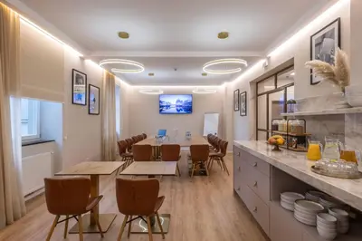 a kitchen and dining room with a table and chairs at PAPPAS hotel&studio in Poděbrady