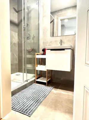 a bathroom with a shower and a sink and a mirror at NewAPT next to Wenceslas Square in Prague