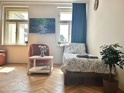 a bedroom with a bed and a table with a plant at NewAPT next to Wenceslas Square in Prague