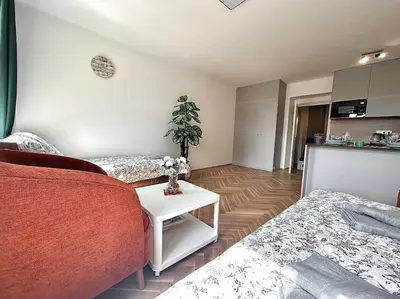 a living room with two beds and a table at NewAPT next to Wenceslas Square in Prague
