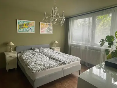 a bedroom with a bed and a chandelier at Good Times in Prague