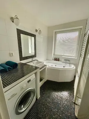a bathroom with a sink and a washing machine at Good Times in Prague