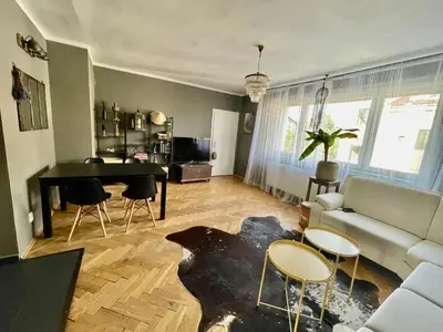 a living room with a couch and a table and chairs at Good Times in Prague