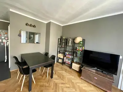 a living room with a black table and a television at Good Times in Prague