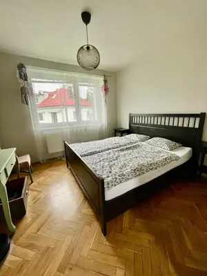 a bedroom with a bed and a wooden floor at Good Times in Prague