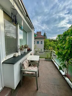 a patio with a bench and a table on a balcony at Good Times in Prague