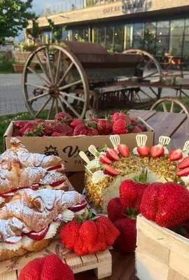 a table with strawberries and pastries on it at Dům ve Vraňanech in Mělník