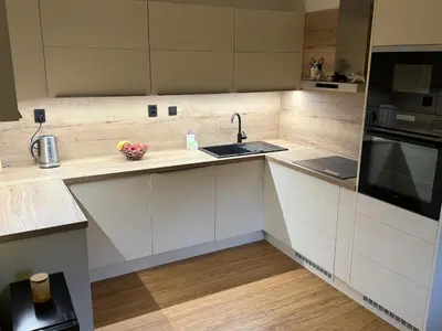 a kitchen with white cabinets and a sink at Dům ve Vraňanech in Mělník