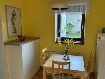 a kitchen with a table with a vase of flowers at Dům ve Vraňanech in Mělník