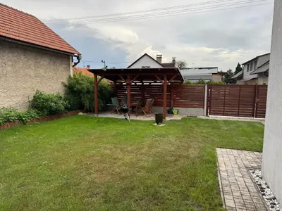 a backyard with a wooden gazebo at Dům ve Vraňanech in Mělník