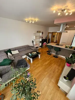 a living room with a couch and a table at Nádherný byt v krásném prostředí in Prague