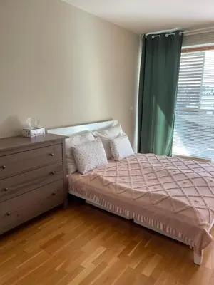 a bedroom with a bed and a dresser and a window at Nádherný byt v krásném prostředí in Prague