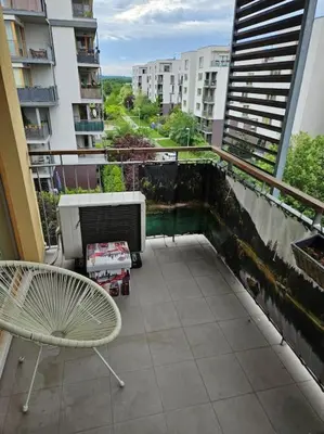 a balcony with a heater and a chair on a building at Nádherný byt v krásném prostředí in Prague