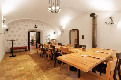 a dining room with wooden tables and chairs at River Apartments in Mladá Boleslav
