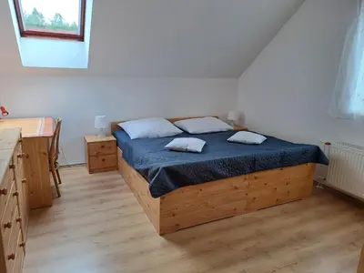 a bedroom with a bed with two pillows on it at Rekreační dům in Dobříš