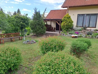 a house with a bench in the yard at Rekreační dům in Dobříš