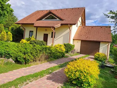 a white house with a brown roof and a driveway at Rekreační dům in Dobříš
