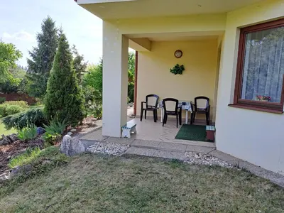 a patio with a table and chairs on a house at Rekreační dům in Dobříš