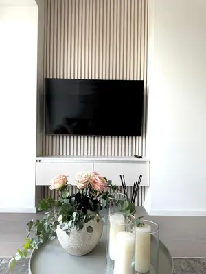 a living room with a table with candles and a tv at Rentero NEW Modern, River View APT near Prague City Center in Prague