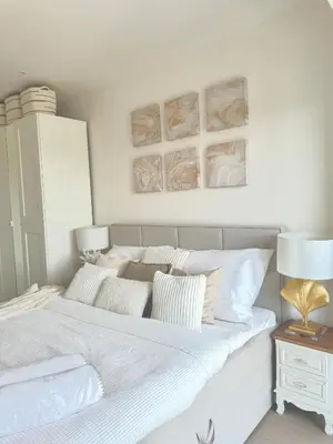 a bedroom with a large white bed with pillows at Rentero NEW Modern, River View APT near Prague City Center in Prague