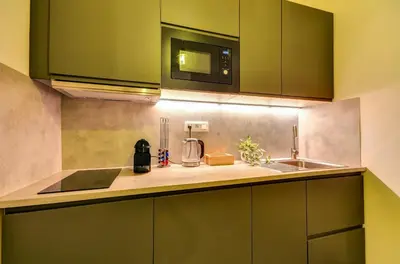 a kitchen with a sink and a microwave at Prague Milada & Heaven Home Apartment in Prague